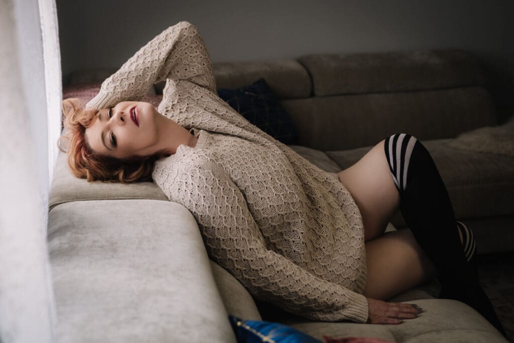 a confident bare elegance client poses in a boudoir photoshoot in south carolina