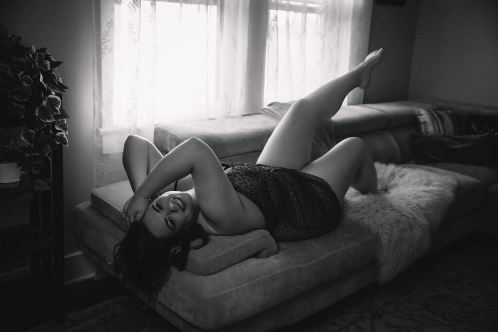 Elegant bare elegance boudoir image with gentle shadows highlighting relaxed self-appreciation charleston south carolina 