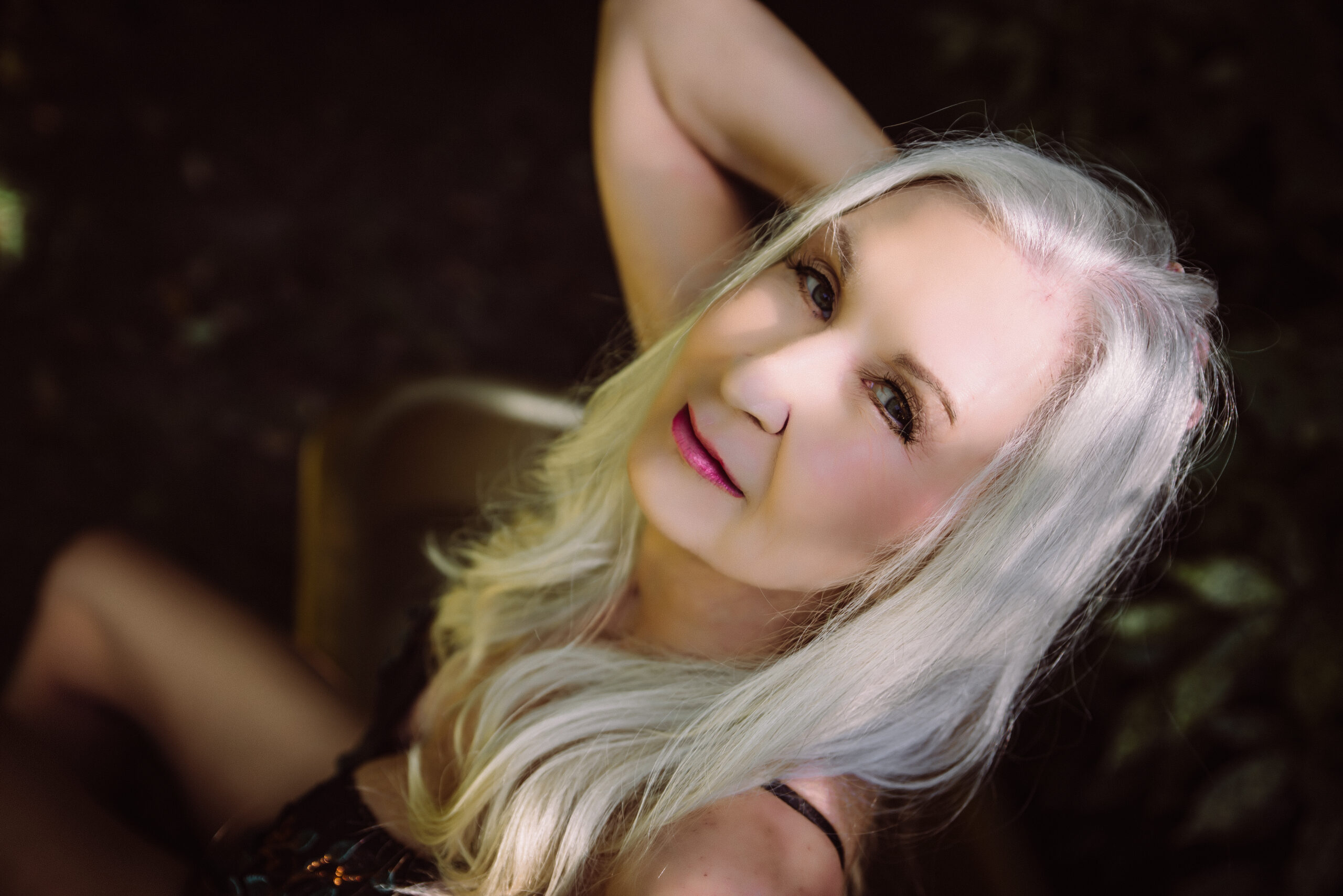 a woman is bathed in sunlight as she gazes confidently into the camera