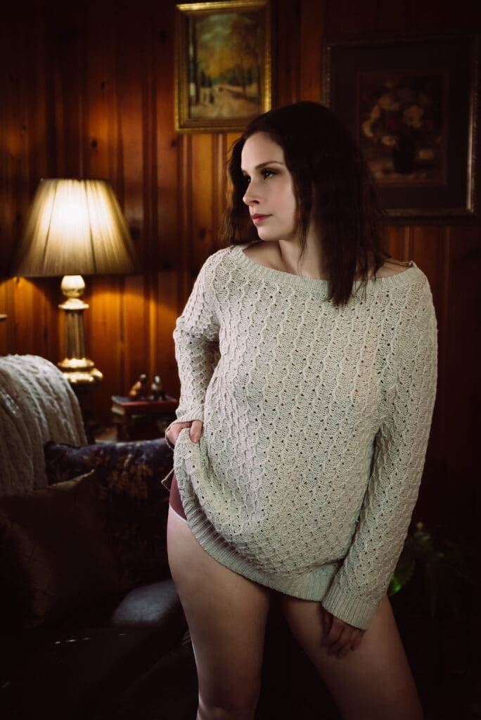 a woman poses confidently in a boudoir photoshoot with bare elegance boudoir