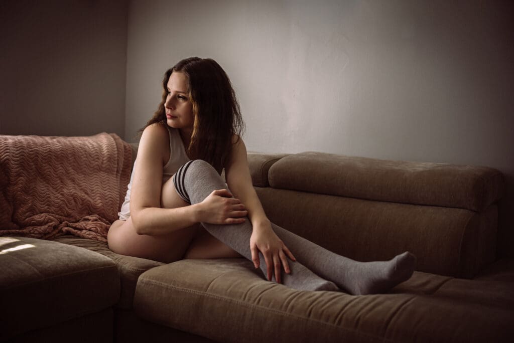 A woman poses in a boudoir photoshoot
