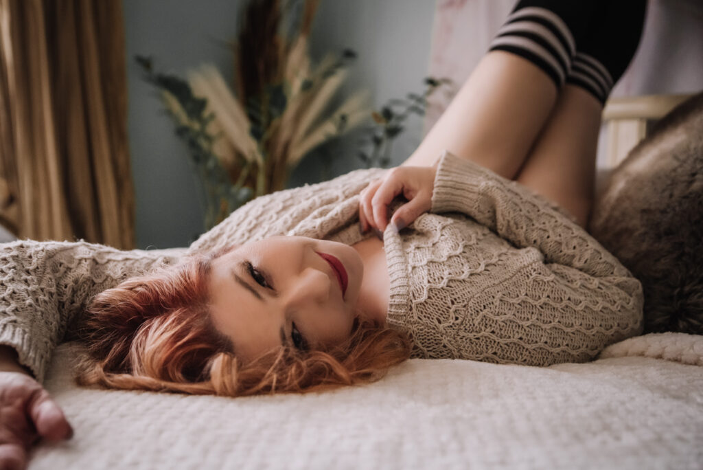 boudoir photo of a woman laying on a bed
