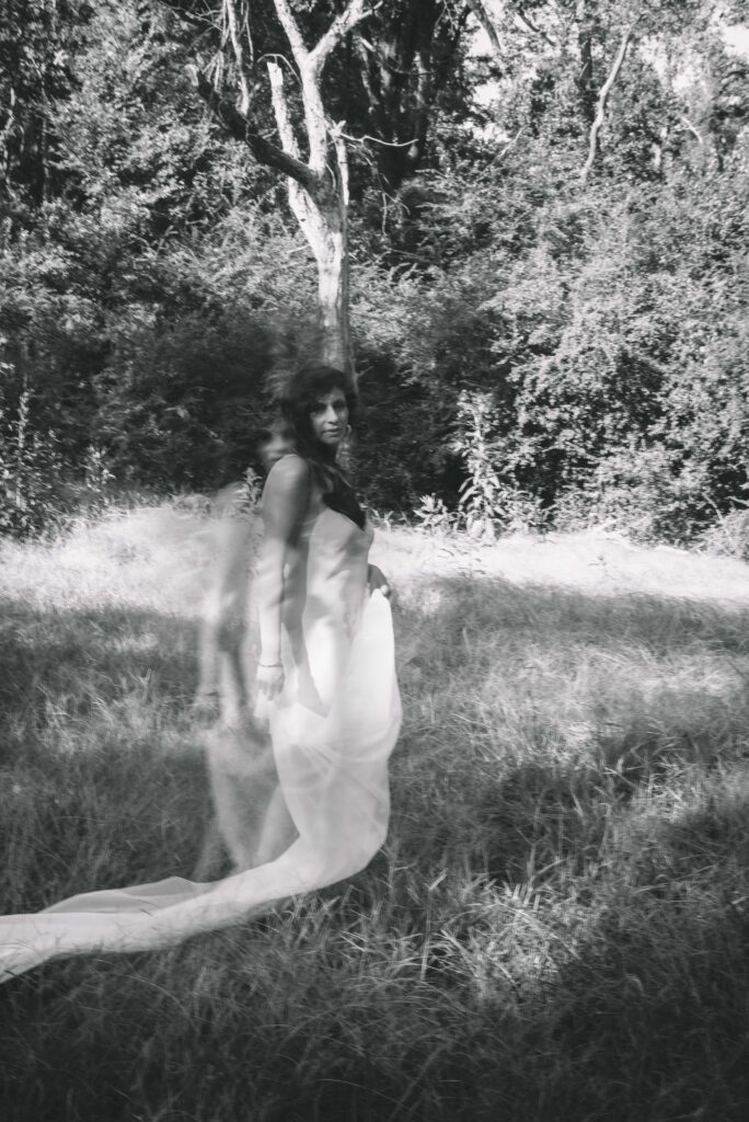 a black and white image of a ghostly woman posing outdoors in south carolina