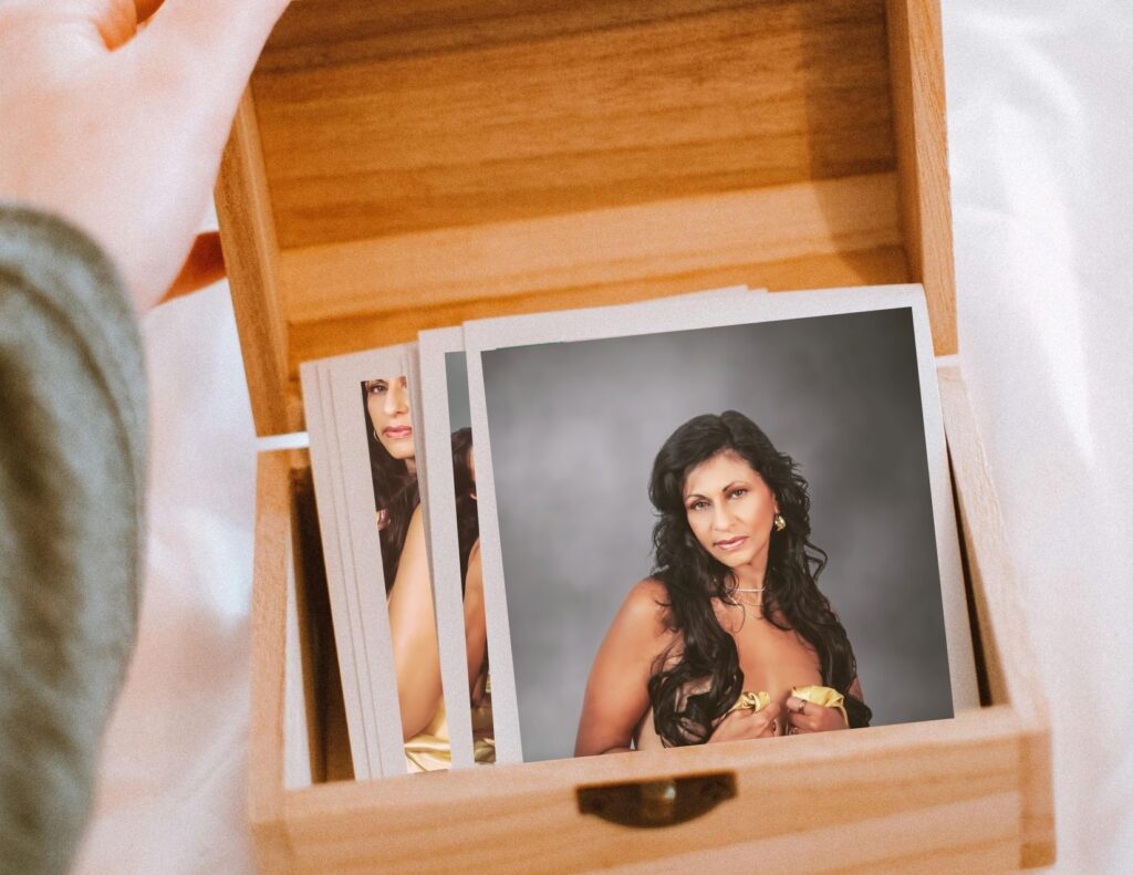 A wooden box of 5 year anniversary boudoir photos is being opened